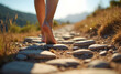 © Marina - Barefoot person walking along a rocky path in nature, sunny day, peaceful exploration