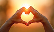 © Radorog. - Two hands with fingers make the shape of a heart, at sunset, sunrise