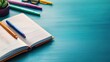 © kwangze - Open notebook with colorful pens, perfect for planning and creative writing.