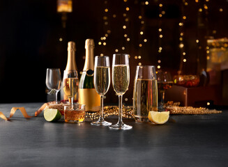 Fototapete - A festive table setting with champagne flutes, bottles, and drinks, including a lime wedge and ribbon.