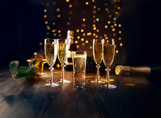 Aufkleber - A wooden table with four champagne flutes and a bottle, lit by twinkling lights.
