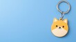 © Daylife - A cute yellow dog keychain against a blue background, showcasing a whimsical design perfect for pet lovers and accessories enthusiasts.