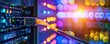 © Faizal - Vibrant Close-Up of a Network Cable Connected to a Server, Colorful Data Center Lights in the Background, Technology and Connectivity Concept