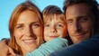 © Elena - A Family Enjoys a Warm Sunset Together, With a Mother and Father Lovingly Embracing Their Happy Child, Radiating Joy and Togetherness in a Serene Outdoor Setting