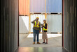 © boonsom - Two loading or warehouse workers standing in front of empty cargo container for inspection. Pregnage woman holding digital tablet and man using walkie talkie in shipping yard