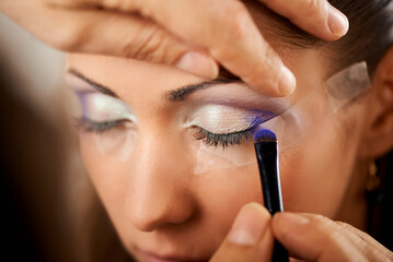 Wall Mural - Professional Makeup Artist Applying Eye shadow