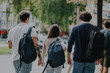 © qunica.com - A group of students, carrying backpacks, walk together in a sunny urban park setting. The image captures a sense of friendship, youth, and casual movement in a natural environment.