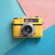 © SaddhaVisual - Yellow vintage film camera, isolated on a Soft blue and Pink Pastel