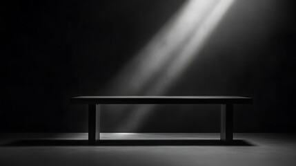 Poster - A dark grey table with soft light shining from the right side, set against an allblack background
