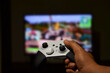 © Oleksandra Dovhai - a man likes to play video games on the console