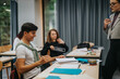 © qunica.com - Students are actively participating in a classroom setting, showcasing enthusiasm and engagement during an interactive learning session. Natural light fills the room, adding to the lively atmosphere.