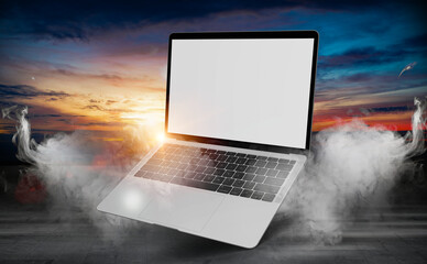 laptop with blank empty white screen display mock up on a dark background dramatic smoke or fog effe