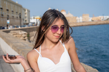 Poster - a young girl enjoys the view of cadiz coastline, andalusia