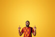 © Prostock-studio - Handsome african american man in traditional clothes pointing up at free space over yellow background
