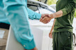 © NanSan - Asian clients engage with a car insurance agent beside a wrecked vehicle. They examine the policy details, assess the damage, and finalize paperwork related to the insurance claim and repairs.