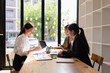 © SOMKID - Asian businesswoman teamwork working on laptop with finances analysis report at desk in office, business financing, accounting banking, Team of creative and business planning,