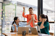 © SOMKID - Excited Asian businesswoman team working together in office, About successful startup projects concept.