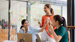 © SOMKID - Excited Asian businesswoman team working together in office, About successful startup projects concept.