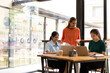 © SOMKID - group of asian businesswoman working on laptop with finances analysis report at desk in office, business financing, accounting banking, Team of creative and business planning,
