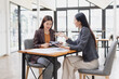 © SOMKID - Two businesswoman working with analysis data investment plan, Business startup and marketing presentation,