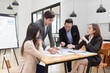 © SOMKID - Asian business teamwork working with analysis report and advisor showing plan, Financial analysis and Marketing teamwork concept.