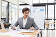 © SOMKID - Happy asian businessman working at desk in office, Excited male person, Employee in achievement, 