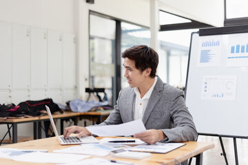 Wall Mural - Happy asian businessman working at desk in office, Excited male person, Employee in achievement, 