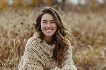 Poster - A smiling woman sits among tall grass, possibly enjoying nature