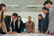 © crizzystudio - Asia business group meeting and discuss new startup concept projects Business team planning, strategic analysis and brainstorming with office paper reports.