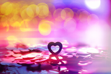 Wall Mural - Abstract colored background. Red toy in the shape of a heart on a glitter and bokeh background.