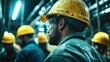 © JoxyAimages - A worker meticulously inspects machinery in a factory setting, donning a yellow safety helmet and goggles, emphasizing industrial safety and vigilance at work.