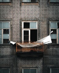 Poster - Vertical shot of a balcony of an old building in Porto, Portugal