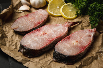 Canvas Print - Sliced ​​raw fish on a dark background. Slices of raw fish