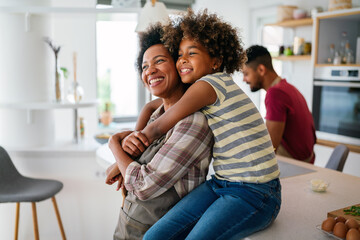 Wall Mural - Portrait of african mother hugging with her daughter, enjoying moment of love, having fun together