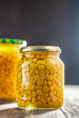 Canvas Print - Canned sweet corn in jar on wooden table.