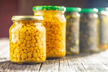 Canvas Print - Canned sweet corn in jar on wooden table.