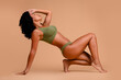 © deagreez - Studio no retouch photo of sporty sensual lady dressed lingerie loving body positive empty space isolated ivory color background