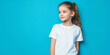 © cato_rium - Caucasian girl with brunette hair in a white T-shirt on a blue background. Mockup banner template for brand, print and advertising. Studio shooting of a cute little model with copyspace
