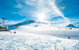 People on ski lift in winter sport resort - Travel and vacation concept - Main focus on left people body