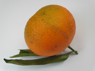 Beautiful orange ripe tangerines lie on a white surface, a delicious aromatic