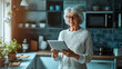 © Teeradej - Senior Woman Using Tablet in Cozy Kitchen