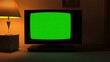 © AH TAR STOCK - A green screen television is on in a dimly lit room