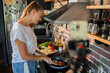 © Geber86 - Young woman cooking healthy vegetables in modern kitchen