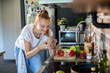 © Geber86 - Young woman filming cooking tutorial in kitchen with fresh vegetables and eggs