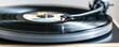 © Manita - Close-up of a vinyl record spinning on a turntable.