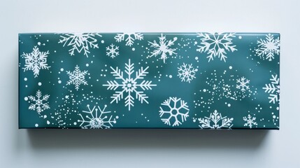 Wall Mural - A holiday-themed gift box with snowflake wrapping paper, isolated on white background