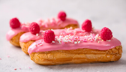 Wall Mural - Tasty eclairs with pink glaze. Sweet food. Yummy dessert. Fresh pastry.