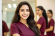© Neha - Young indian female hair Stylist, Beautician and staff of a beauty salon in maroon color t - shirts posing