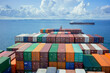 © Connect Images - Aerial view of colorful shipping containers stacked on a cargo ship with an expansive ocean and a cloudy sky in the background.