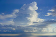 © Connect Images - Majestic cumulus cloud towering over a serene sea under a blue sky with soft light piercing through, South China Sea